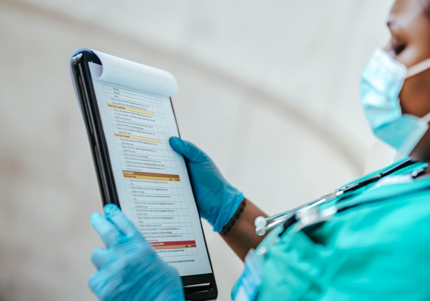 A female doctor is reading a questionaire